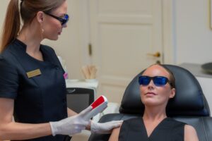 Kosmetisk sygeplejerske Desiree Hove med beskyttelsesbriller gør klar til permanent hårfjerning med IPL